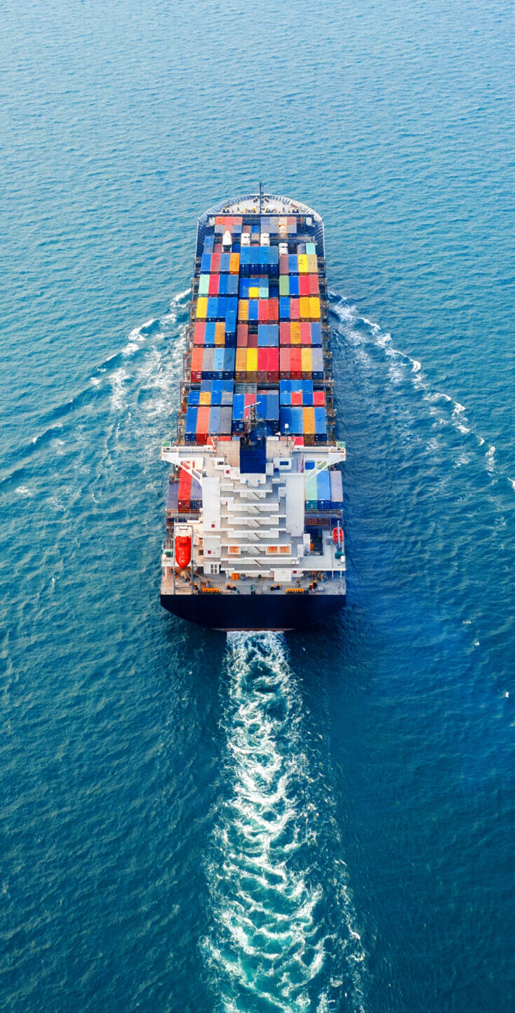 Aerial view of container cargo ship in sea.